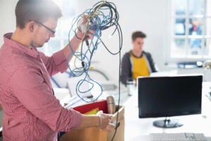 Technicians handling IT equipment during an office relocation with protective packing in New York